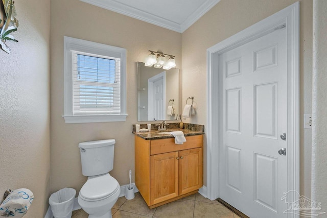 bathroom with vanity, toilet, crown molding, and tile patterned flooring