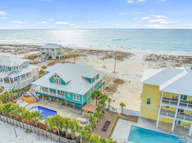 aerial view with a water view and a beach view