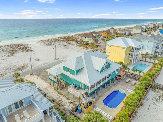 birds eye view of property featuring a beach view and a water view