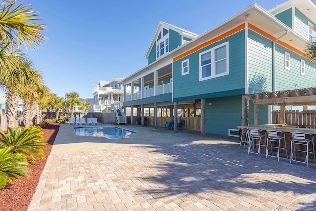 view of pool featuring a patio area and exterior bar