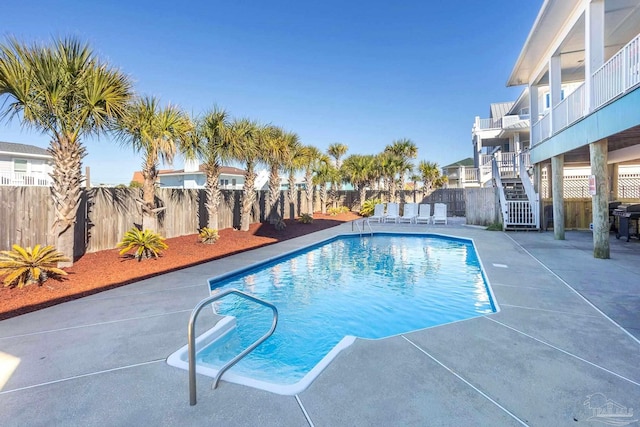 view of pool with a patio area and grilling area