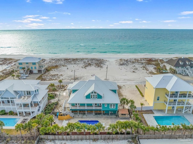 bird's eye view with a water view and a beach view