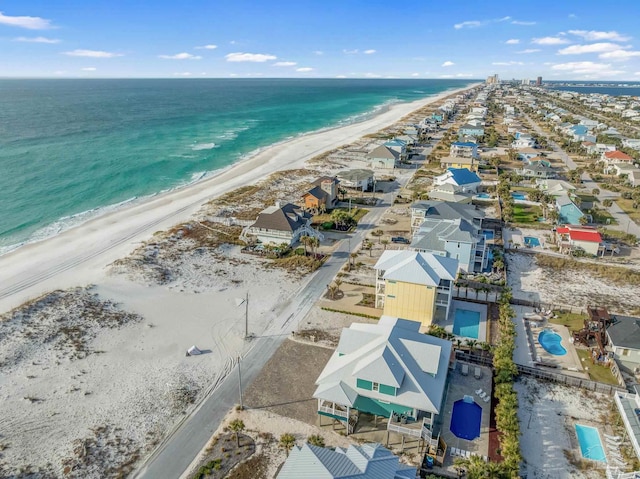 drone / aerial view featuring a water view and a beach view