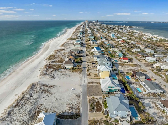 drone / aerial view featuring a water view and a view of the beach