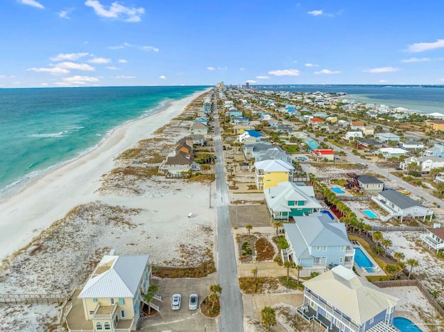 birds eye view of property with a water view and a view of the beach