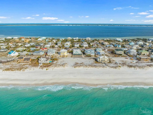 birds eye view of property featuring a beach view and a water view