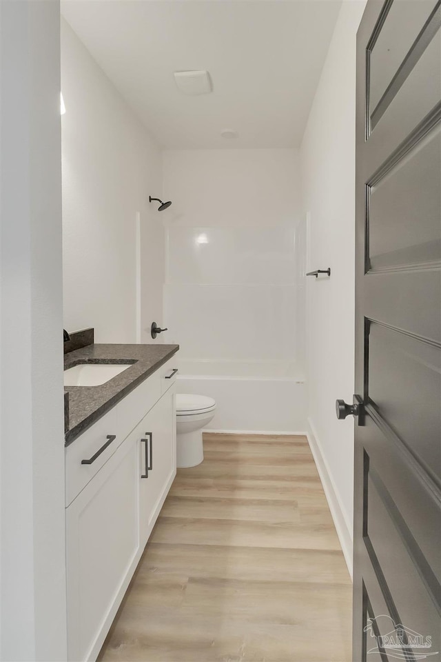 2116 W De Soto St, Pensacola, FL 32505 - bathroom featuring vanity, toilet, wood finished floors, and shower / washtub combination
