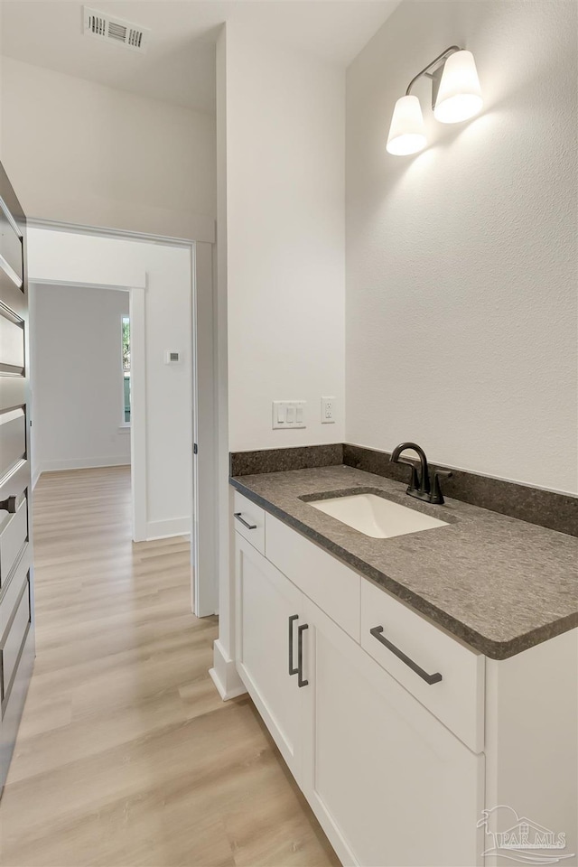2116 W De Soto St, Pensacola, FL 32505 - bathroom featuring vanity and wood finished floors