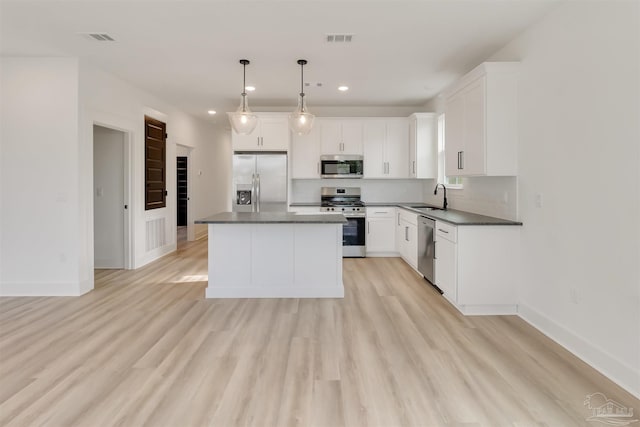 2116 W De Soto St, Pensacola, FL 32505 - kitchen with appliances with stainless steel finishes, a sink, dark countertops, recessed lighting, and a kitchen island