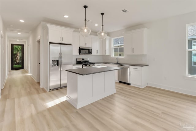 2116 W De Soto St, Pensacola, FL 32505 - kitchen with appliances with stainless steel finishes, a sink, dark countertops, light wood finished floors, and recessed lighting