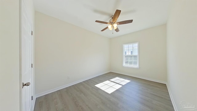 spare room with ceiling fan and light wood-type flooring