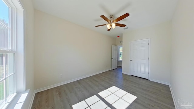 unfurnished bedroom with ceiling fan, light hardwood / wood-style flooring, and multiple windows