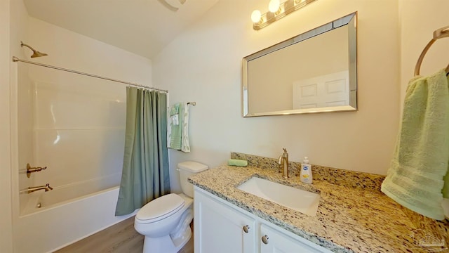 full bathroom with shower / bath combo, wood-type flooring, vaulted ceiling, toilet, and vanity