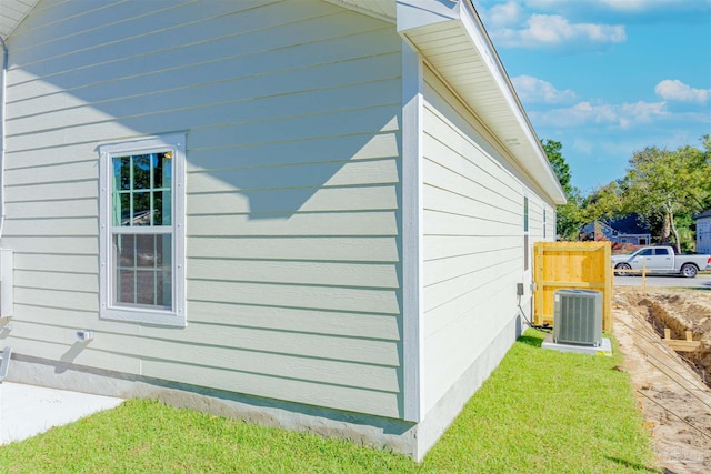 view of side of home featuring central AC