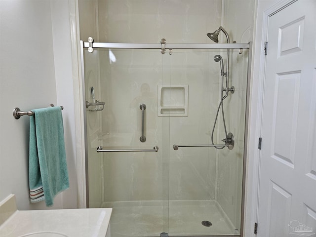 bathroom with vanity and a shower with shower door