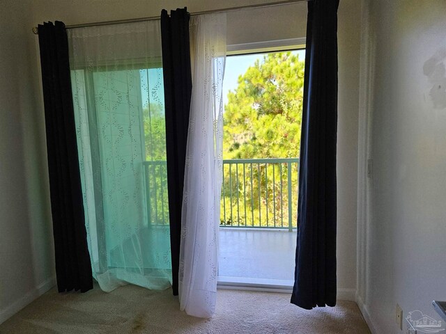 doorway with light colored carpet