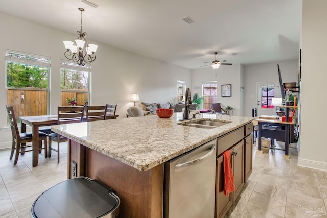 kitchen with visible vents, stainless steel dishwasher, open floor plan, a kitchen island with sink, and a sink