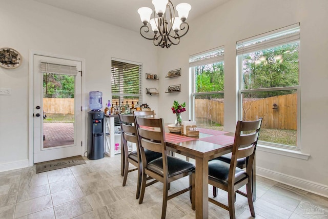 dining area with baseboards and a notable chandelier