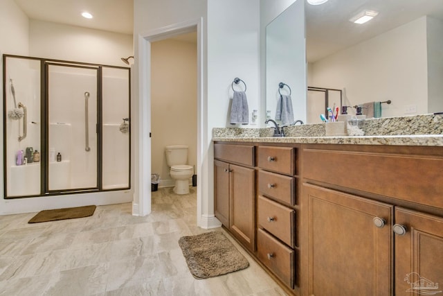 full bathroom with a stall shower, baseboards, vanity, and toilet