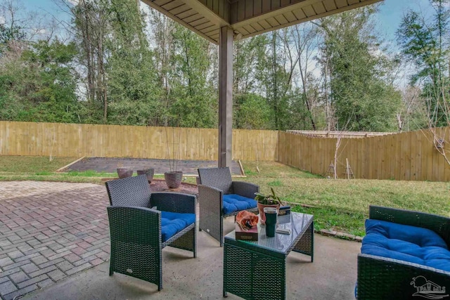 view of patio featuring a fenced backyard and an outdoor living space