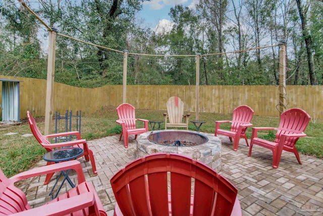 view of patio / terrace with an outdoor fire pit and a fenced backyard