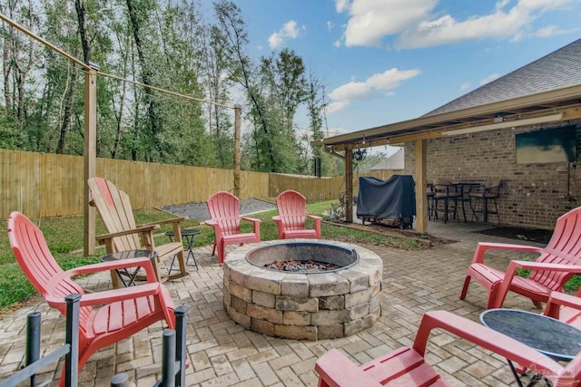 view of patio / terrace featuring a fenced backyard, a grill, and a fire pit