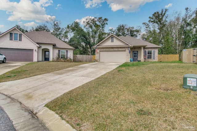 view of front of home with a garage, driveway, a front yard, and fence