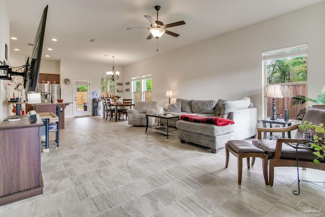 living area featuring ceiling fan with notable chandelier and recessed lighting