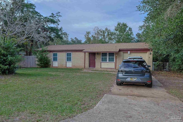 ranch-style house with a garage and a front lawn