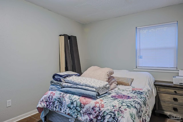 bedroom with dark tile patterned floors