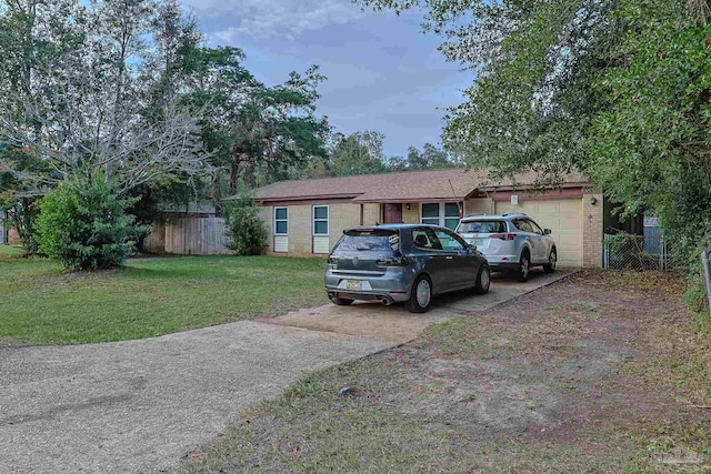 single story home with a front yard and a garage