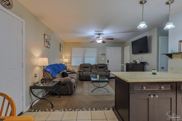 tiled living room with ceiling fan