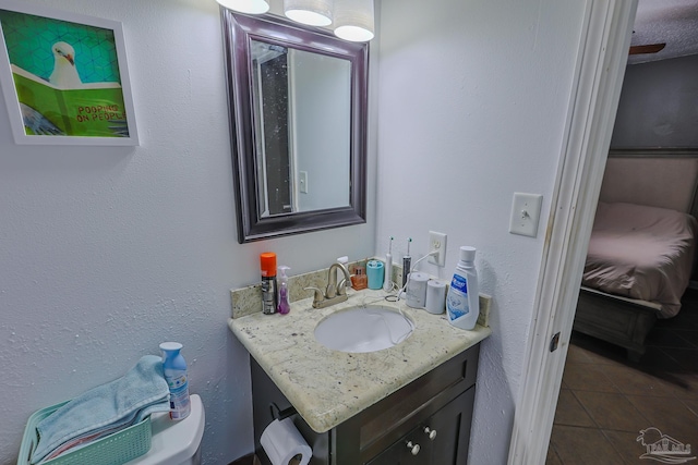 bathroom with tile patterned floors, vanity, and toilet