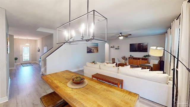 living room featuring ceiling fan and light wood-type flooring