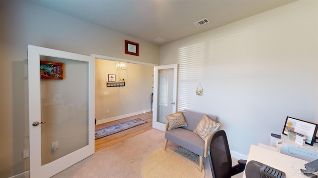 carpeted office with french doors