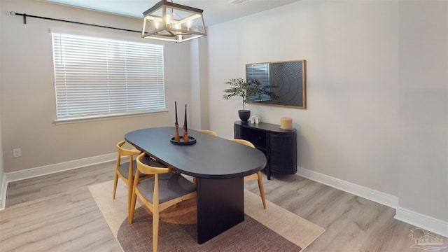 dining room featuring a notable chandelier and light wood-type flooring