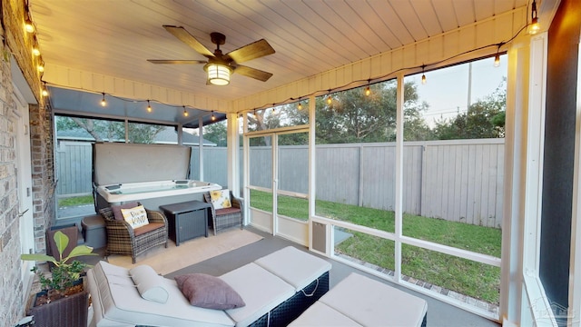 unfurnished sunroom with ceiling fan and wooden ceiling