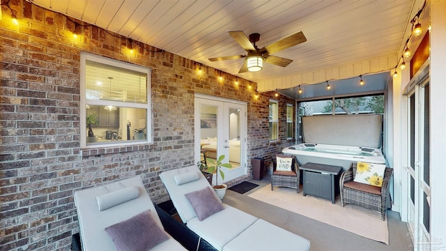 view of patio featuring ceiling fan and a jacuzzi