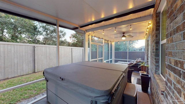 sunroom / solarium featuring ceiling fan