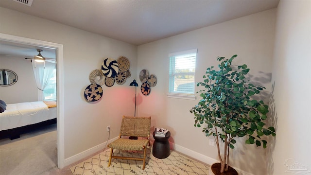 living area featuring light carpet