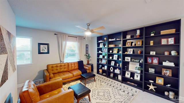 sitting room with ceiling fan, a wealth of natural light, and carpet flooring