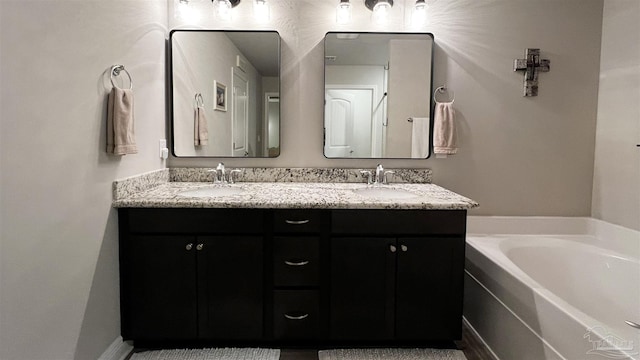 bathroom with a washtub and vanity