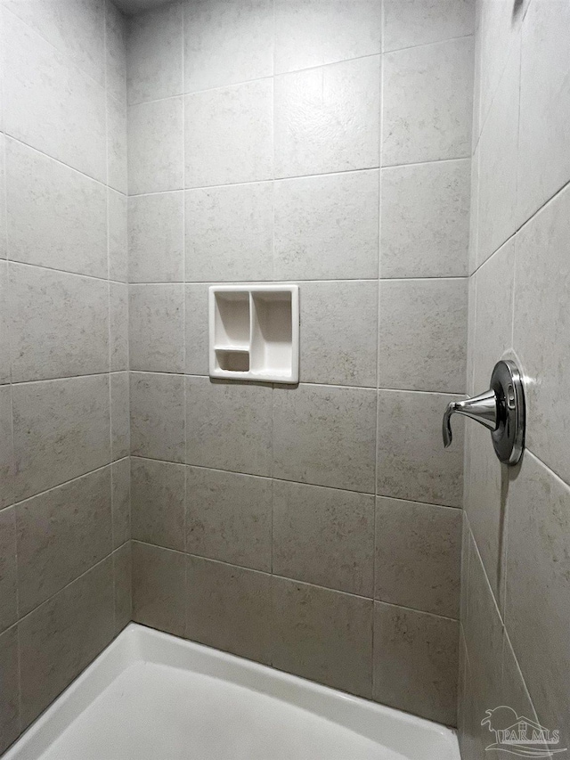 bathroom with tiled shower