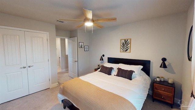 carpeted bedroom featuring ceiling fan and a closet