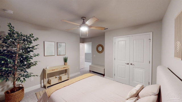 carpeted bedroom featuring ceiling fan and a closet