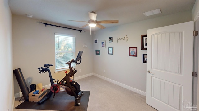 exercise area featuring ceiling fan and light colored carpet