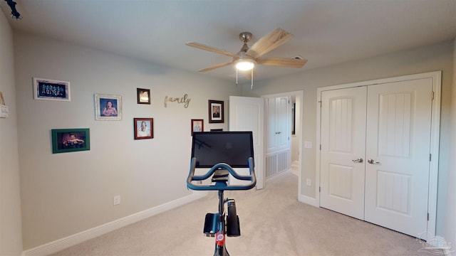 workout room with light carpet and ceiling fan