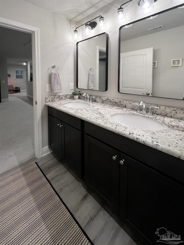 bathroom featuring hardwood / wood-style flooring and vanity