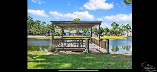 dock area with a pergola, a water view, and a yard