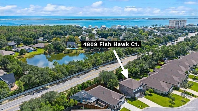 birds eye view of property with a water view